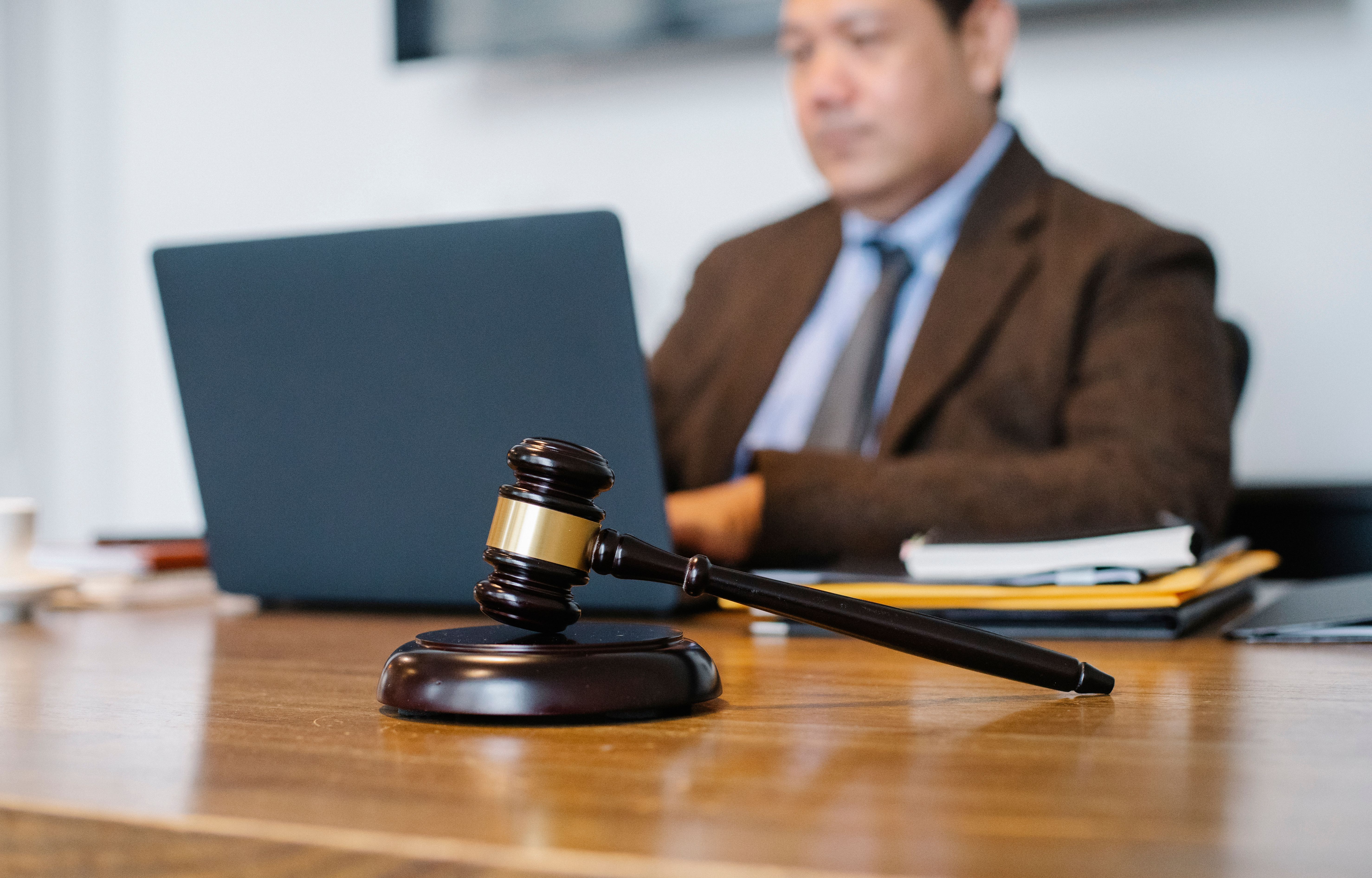 photo of an attorney at a desk reviewing a laptop with the Google Ads interface visible, professional and calm, to anchor the FAQ section